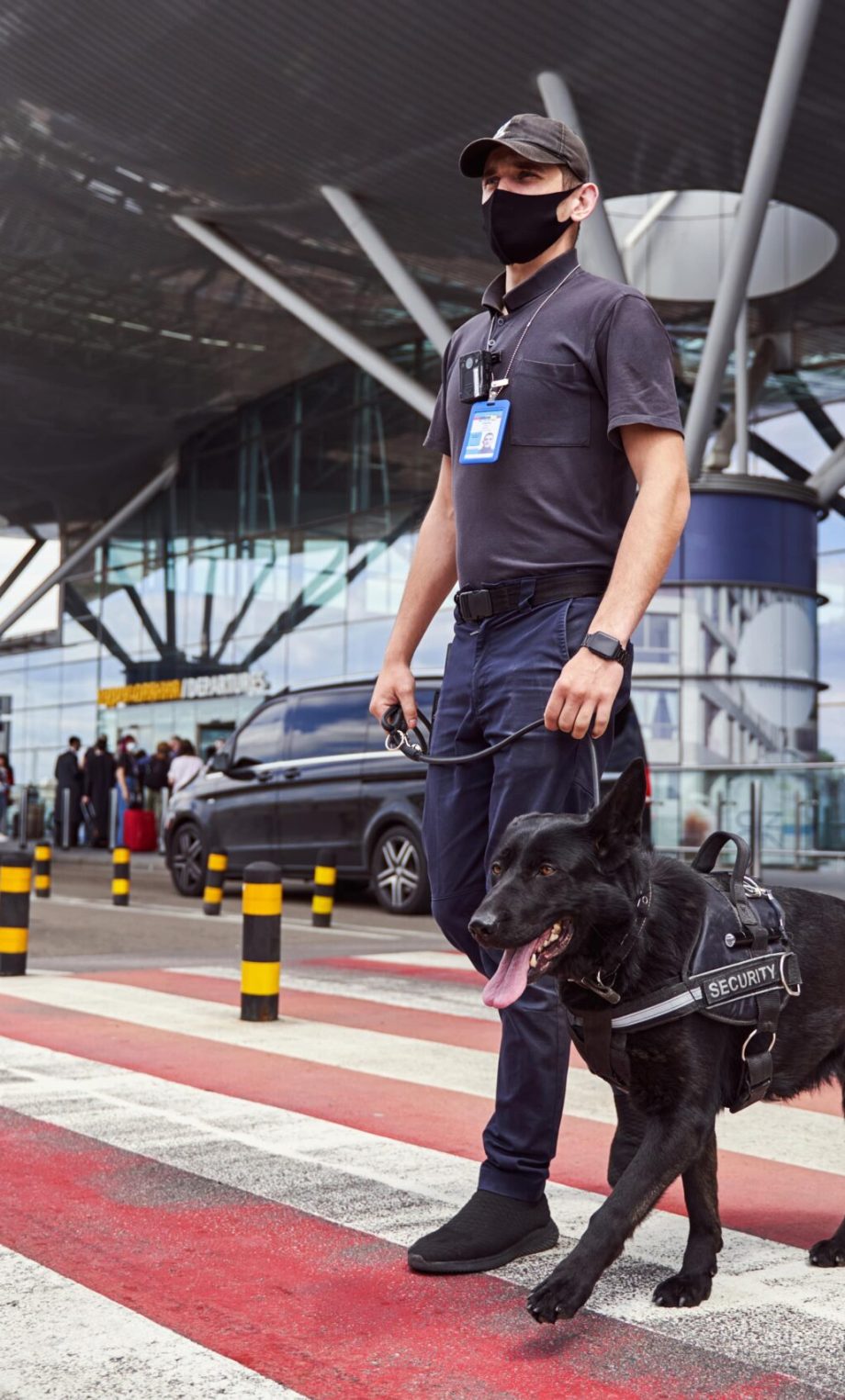 male-security-worker-with-police-dog-crossing-the-2021-09-04-14-24-12-utc-min